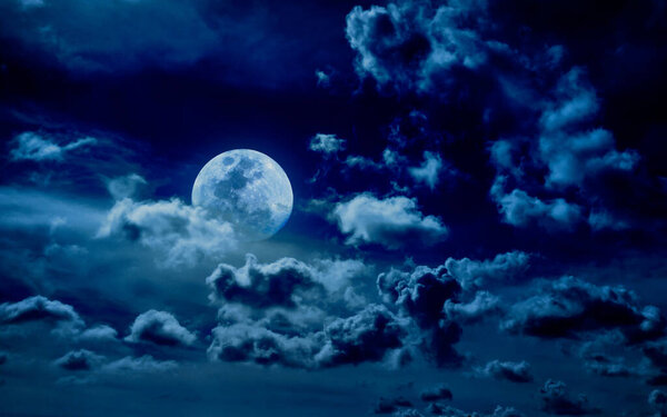 Full moon and clouds in the night sky. Night sky background with moon and clouds
