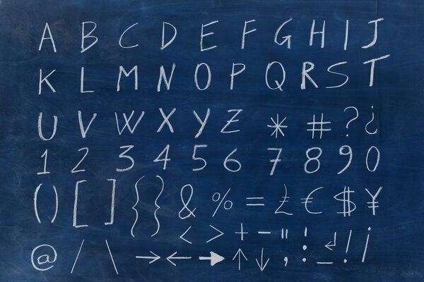 Chalk alphabet on blue wooden board