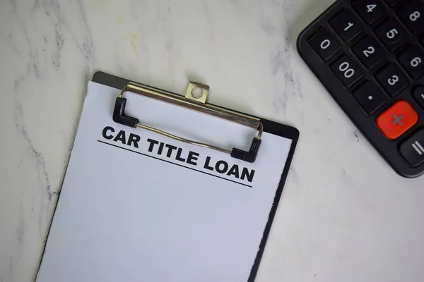 Car Title Loan write on a paperwork isolated on Wooden Table.