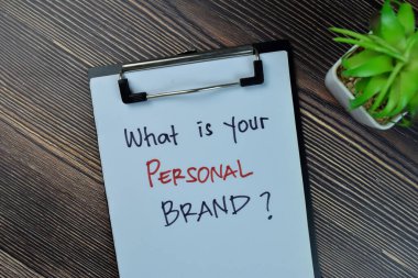 Concept of What is Your Personal Brand? write on a paperwork isolated on Wooden Table.