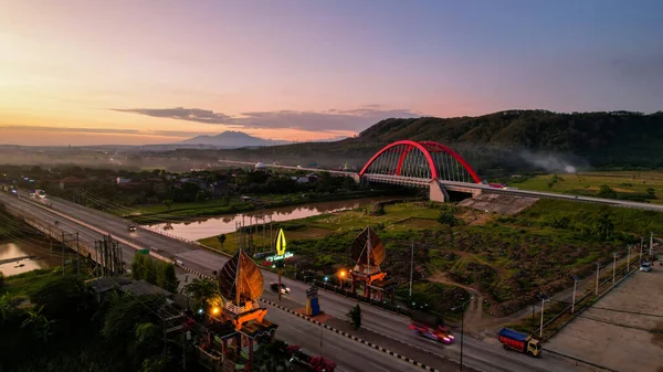 Aerial view of the Kalikuto Bridge, an Iconic Red Bridge at Trans Java Toll Road, Batang when sunrise. Central Java, Indonesia, August 24, 2022