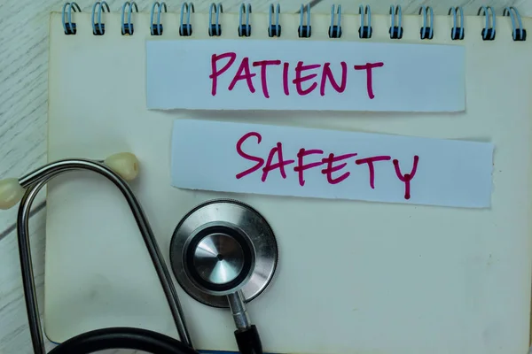 Concept of Patient Safety write on sticky notes isolated on Wooden Table.