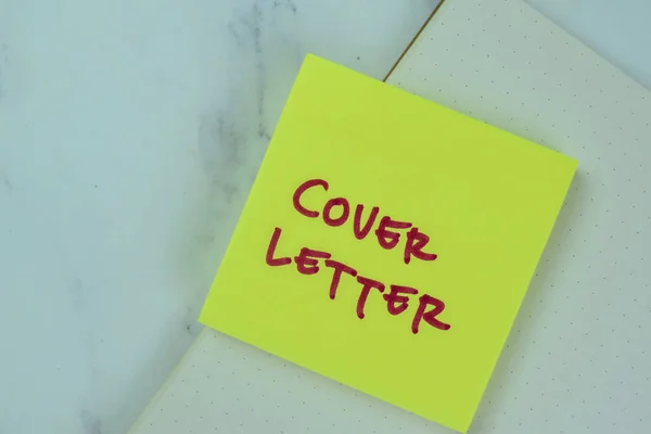 Concept of Cover Letter write on sticky notes isolated on Wooden Table.