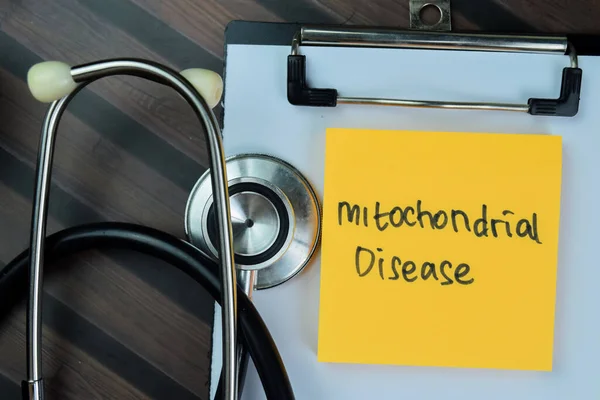 Concept Mitochondrial Disease Write Paperwork Isolated Wooden Table — Stock Photo, Image