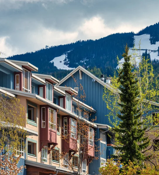 Top of residential building on mountain background. Apartment building in sunlight on overcast day