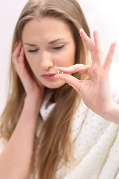 Young woman with a pill — Stock Photo, Image