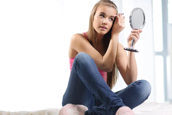 Girl pulls out her eyebrows with tweezers — Stock Photo, Image