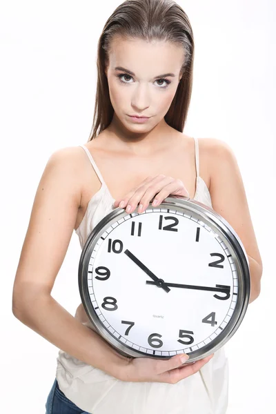 Girl with a clock on white background — Stock Photo, Image