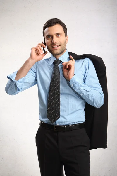 Portret młodego biznesmena za pomocą telefonów komórkowych — Zdjęcie stockowe