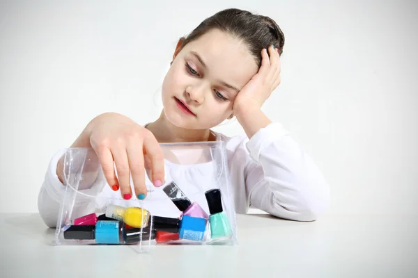 Little girl and nail polishes — Stock Photo, Image