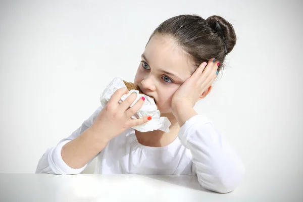 Beautiful girl eating bread — Stock Photo, Image