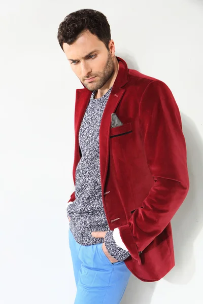 Handsome man posing in a red jacket — Stock Photo, Image