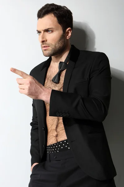 Sexy male model points his finger — Stock Photo, Image