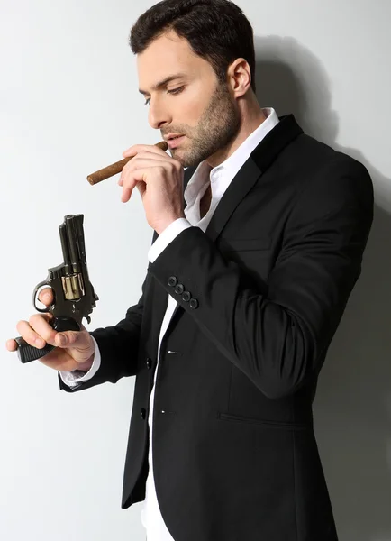 Man Holding a fire gun and smoking a cigar — Stock Photo, Image