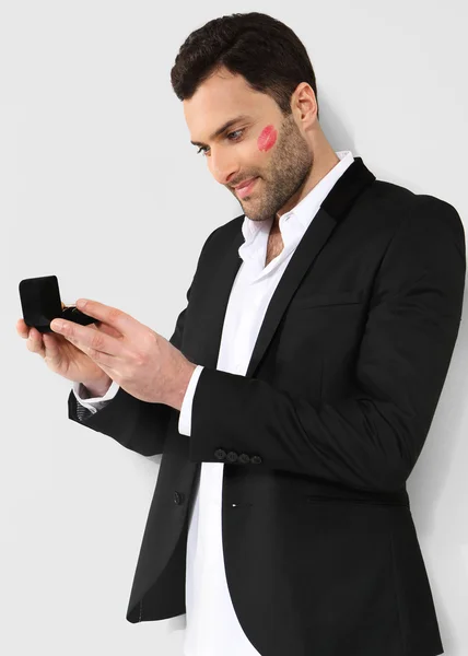 Attractive man looking at black box with cufflinks — Stock Photo, Image