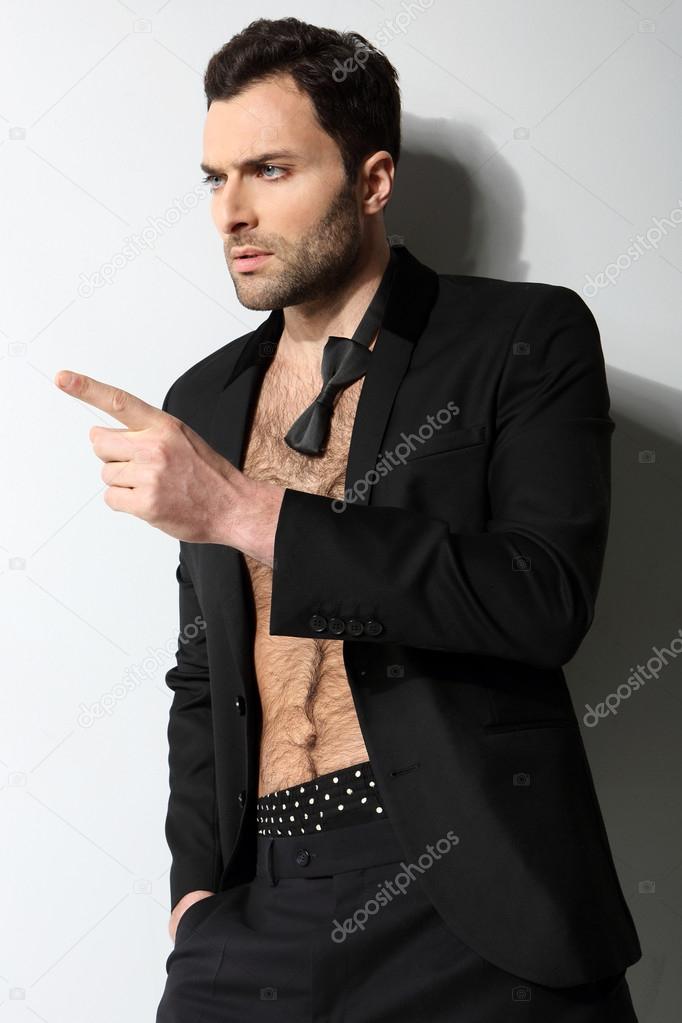 Sexy male model points his finger