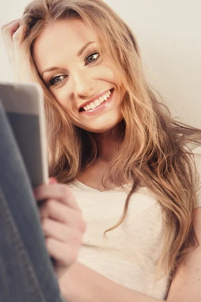 Beautiful girl reading e-book — Stock Photo, Image