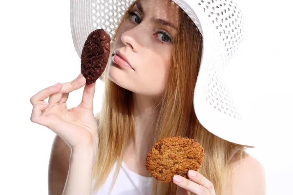Cute young woman eats cookies — Stock Photo, Image