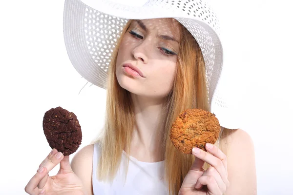 Cute young woman eats cookies — Stock Photo, Image