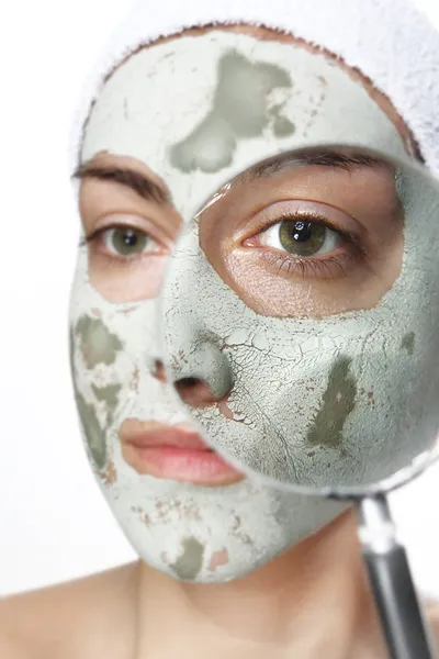 Green mask and magnifying glass — Stock Photo, Image