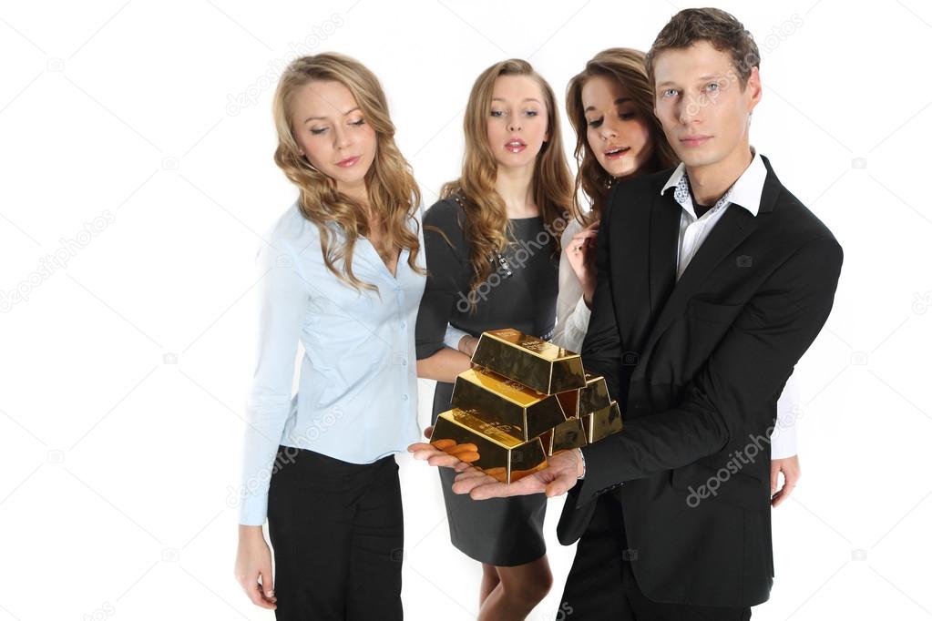 Group of business people and the pyramid of gold bars