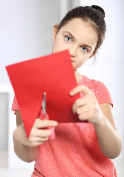 Pretty girl with scissors cuts heart — Stock Photo, Image