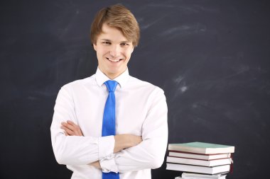 Happy student on the background of blackboard clipart