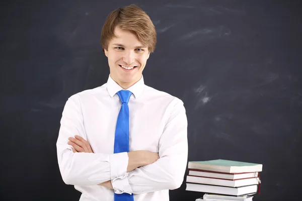 Happy student on the background of blackboard — Stock Photo, Image