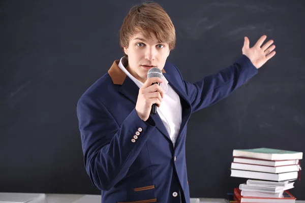 Young man with a microphone during the presentation of energy — Stock Photo, Image