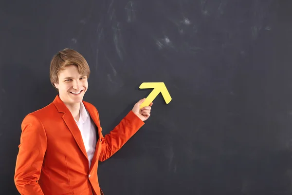 Happy man with a yellow arrow — Stock Photo, Image