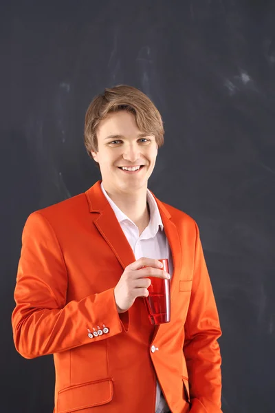 Smiling young worker with red mug — Stock Photo, Image