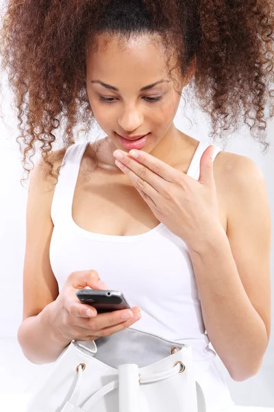 Good news - dark skinned girl reads sms — Stock Photo, Image