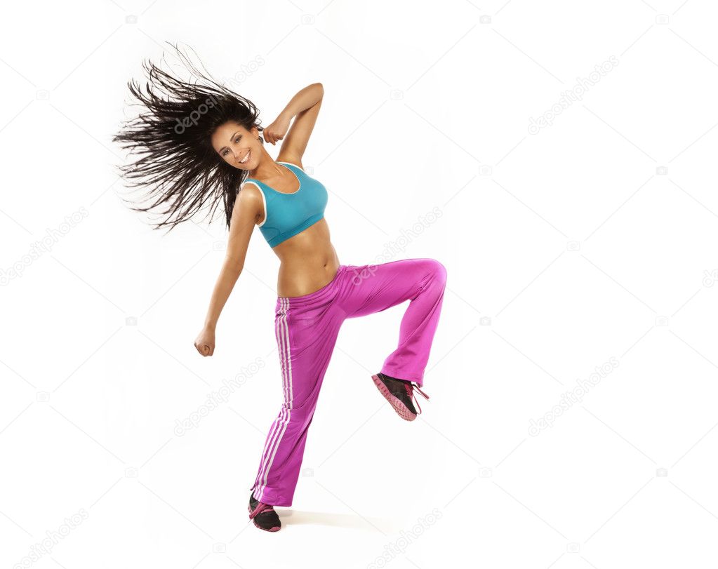 Brunette smiling woman with perfect fitness shape jumping and sm