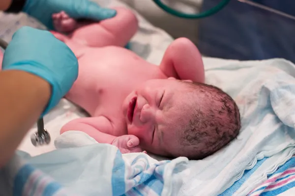 Newborn baby being examined — Stock Photo, Image