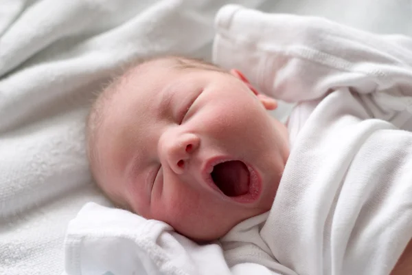 Sleeping baby yawning Stock Image