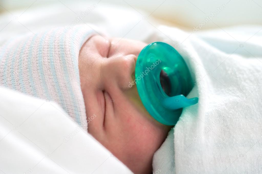 Newborn sleeping with pacifier Stock Photo by ©vividpixels 19045391