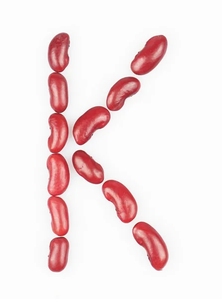Letter K made of red bean on white background — Stock Photo, Image