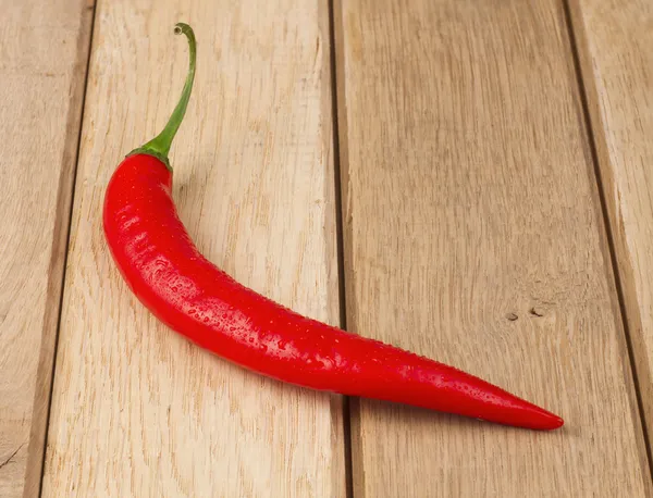 Red chili peppers on wooden background — Stock Photo, Image