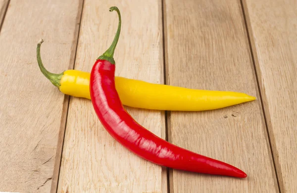 Red chili peppers on wooden background — Stock Photo, Image