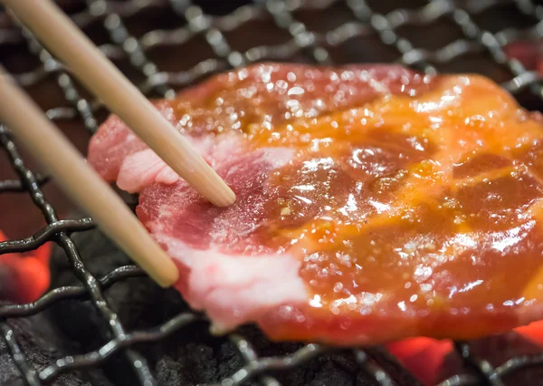 Grill pork using chopstick — Stock Photo, Image