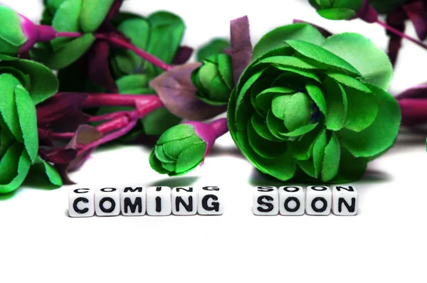 Coming soon with dark green flowers — Stock Photo, Image