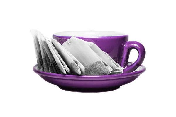 Magenta cup and plate with teabags — Stock Photo, Image