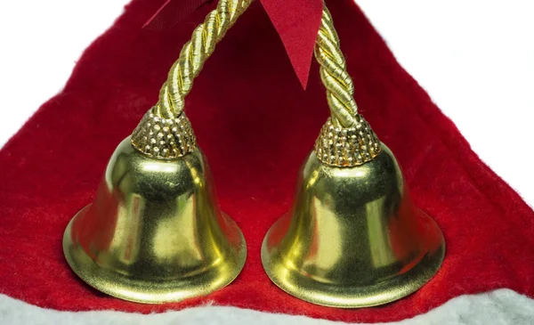 Real christmas bells on red cloth — Stock Photo, Image