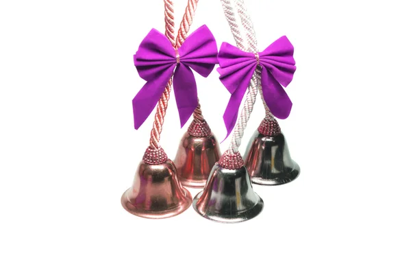 Four real christmas bells with pink ribbon — Stock Photo, Image