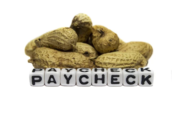 Peanuts in paycheck — Stock Photo, Image