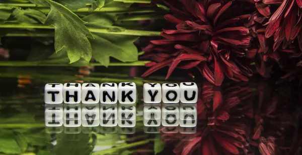 Thank you with red flowers and green leaves — Stock Photo, Image