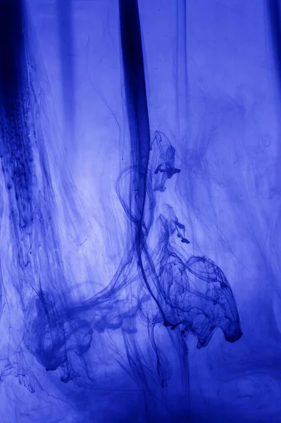 Free flowing blue ink in water and Alcohol ink fluid abstract texture fluid art with liquid with shades.