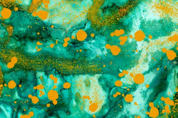 Gold dust and drops on green Alcohol ink fluid abstract texture fluid art with gold glitter and liquid with shades.