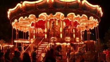 Bursa, Turkey - August 06 2022: People riding a carousel at night in an amusement park in Bursa