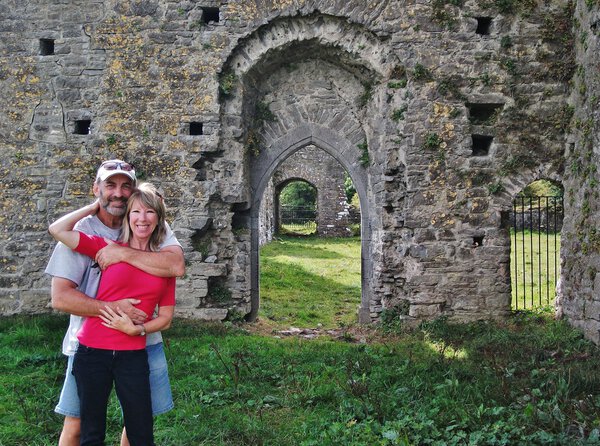 A loving couple among ruins of a castle